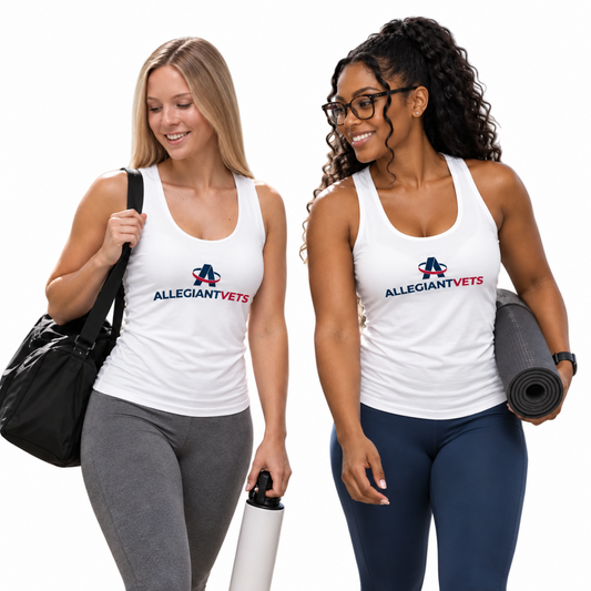 Two women walking outdoors on a sunny day, both wearing white tank tops with the 'ALLEGIANTVETS' logo printed on the chest. The woman on the left wears gray leggings and carries a black shoulder bag, while the woman on the right wears navy leggings and holds a rolled-up gray yoga mat.