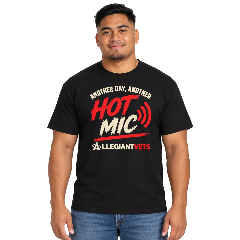 A man wearing a black graphic t-shirt with red and white text that reads 'ANOTHER DAY, ANOTHER HOT MIC' and 'ALLEGIANTVETS'.