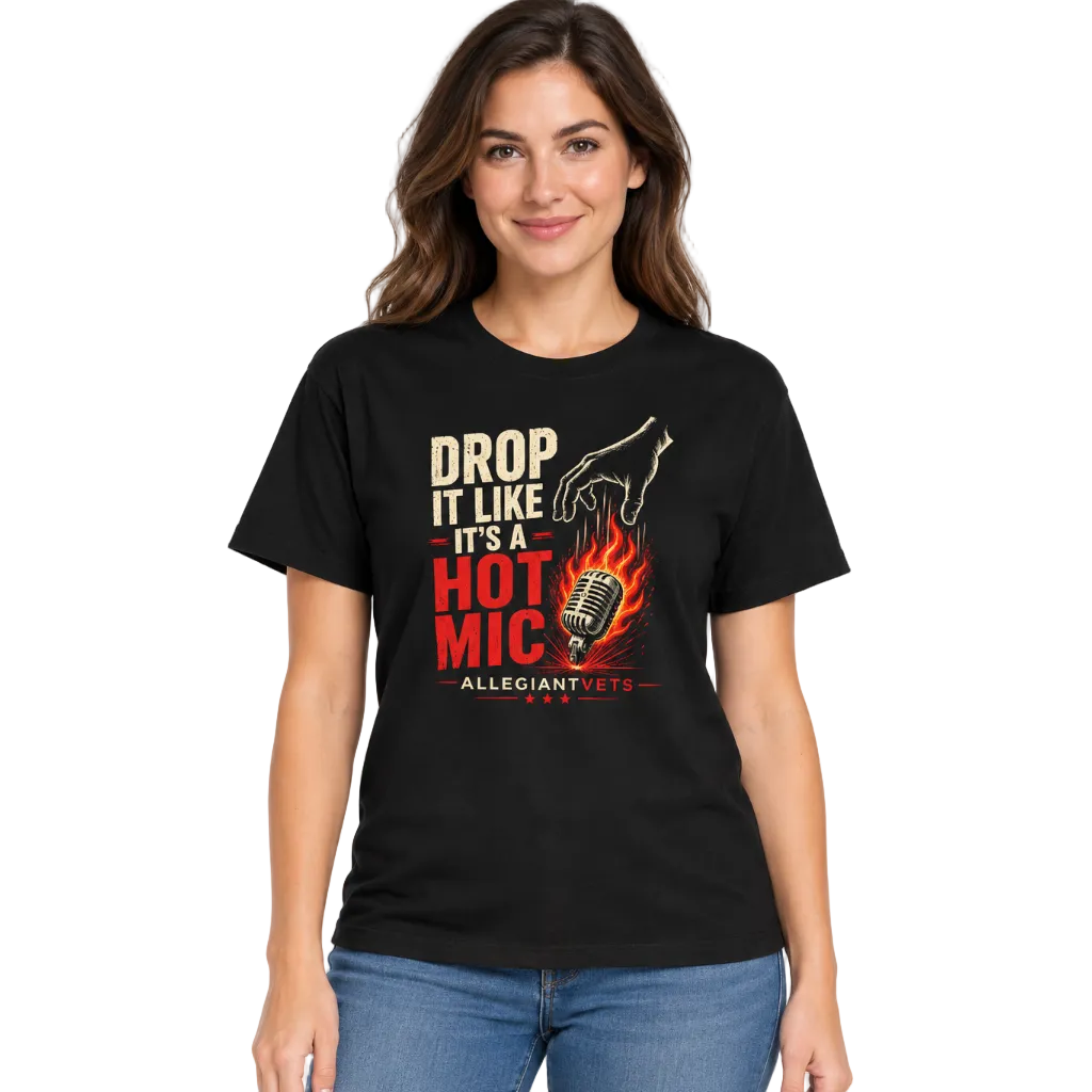 A woman modeling a black graphic t-shirt with the text 'DROP IT LIKE IT'S A HOT MIC - ALLEGIANT VETS' in red, white, and yellow, paired with blue jeans against a plain white background.