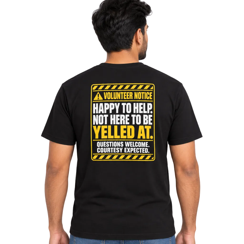 A man viewed from the back wearing a black t-shirt with a yellow and white 'Volunteer Notice' graphic on the back, paired with blue jeans, against a plain white background.