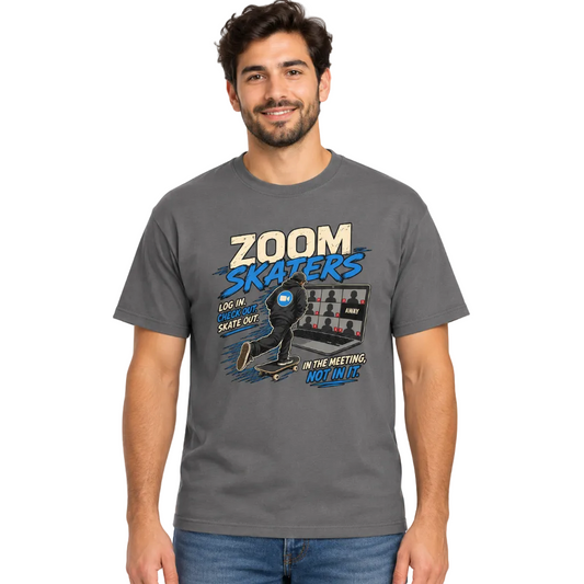 A man wearing a dark gray graphic t-shirt with a 'Zoom Skaters' design, paired with blue jeans, against a plain white background.