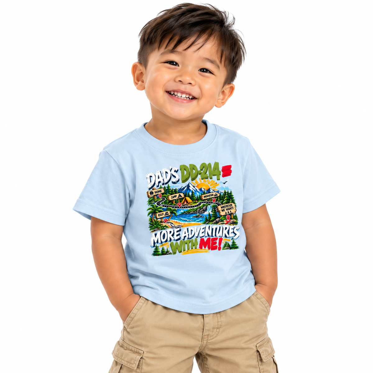 A smiling young boy wearing a light blue graphic t-shirt and khaki cargo shorts, standing against a solid white background.