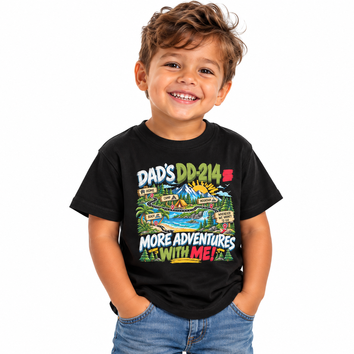 A young boy smiling and wearing a black graphic t-shirt with a colorful cartoon map design and the text 'DAD'S DD-214 = MORE ADVENTURES WITH ME!'.