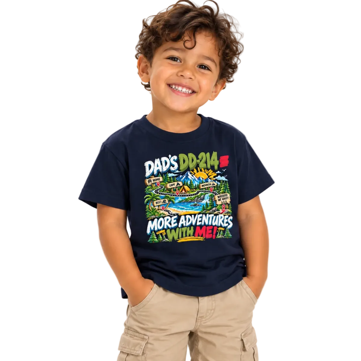 A smiling young boy with curly brown hair wearing a navy blue graphic t-shirt and khaki cargo shorts, standing against a solid white background.