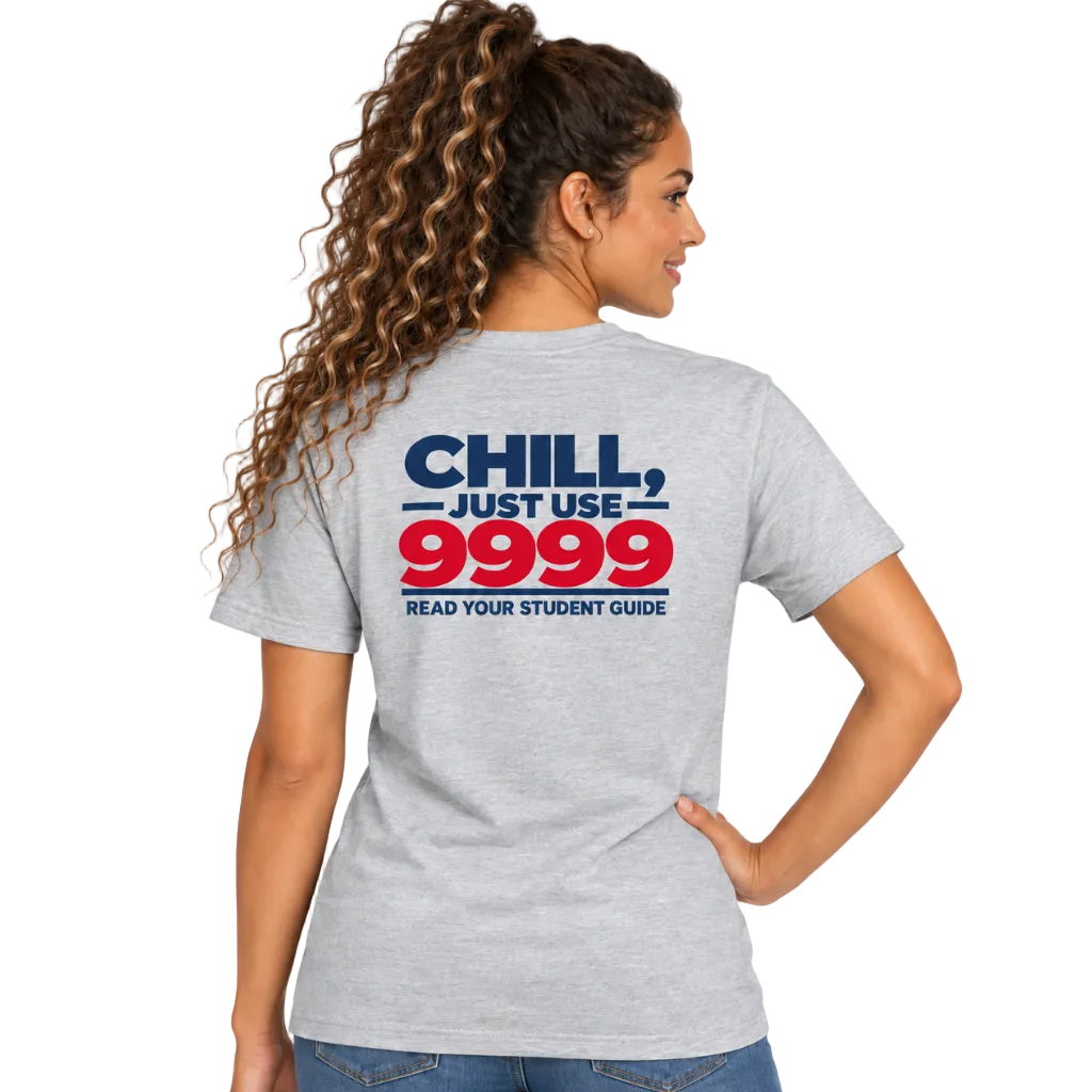A woman shown from the back wearing a heather gray graphic T-shirt with the text 'CHILL, JUST USE 9999 READ YOUR STUDENT GUIDE' in navy and red, paired with blue jeans on a white studio background.