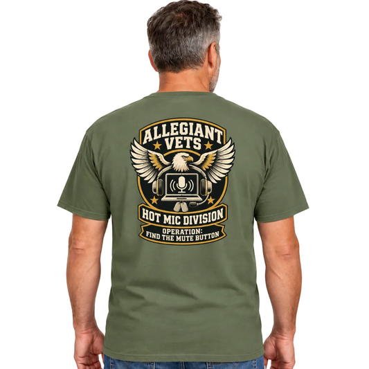A man viewed from the back wearing an olive green t-shirt with a large graphic print on the back. The graphic features an eagle, a hot air balloon with a microphone, and the text 'ALLEGIANT VETS HOT MIC DIVISION OPERATION: FIND THE MUTE BUTTON'.