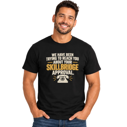 A smiling man wearing a black graphic t-shirt with a humorous message about 'Skillbridge Approval' in white and gold text, paired with blue jeans, against a plain white background.